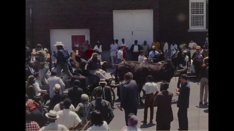 CIRCA 1968 - The Poor People's March on Washington begins, with crowds following a horse-drawn wagon.
