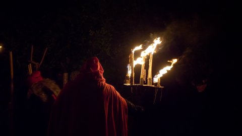 Canzo (Italy), 30 January 2020 - Old men and Candelabrum-bearer bringing the witch to pyre during “Giubiana” (a traditional celebration in the northern Italian, a puppet of an old witch is burnt) 