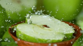 Super Slow Motion Shot of Water Splashing on Fresh Cutted Green Apple at 1000fps. - Powered by Shutterstock - Get 15% off with code: PIKWIZARD15