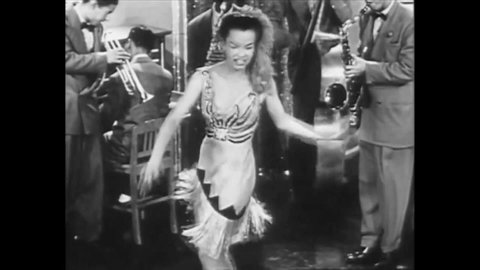 CIRCA 1944 - Skeets Tolbert and his orchestra perform Blitzkrieg Bombardier, featuring a saxophone solo and a female dancer.