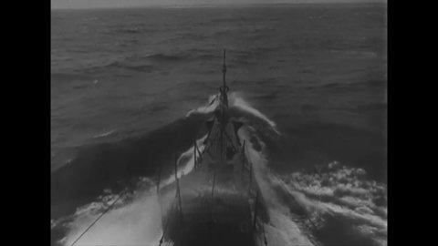 CIRCA 1942 - A US Navy submarine submerges, and successfully fires a torpedo at a Japanese ship.