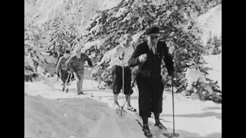 CIRCA 1936 - People go cross-country skiing and ride in horse-drawn sleighs through Garmisch-Partenkirchen in the Bavarian Alps.