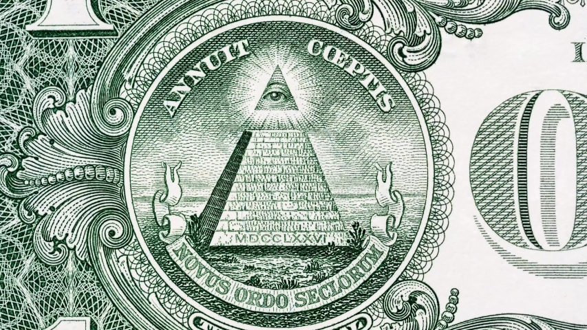 Creative 4k video of details of a 1 american dollar banknote macro closeup with a pyramid and the effect of a glowing mason eye on top. Pyramid close-up on a banknote of 1 US dollars.  Royalty-Free Stock Footage #1047407119