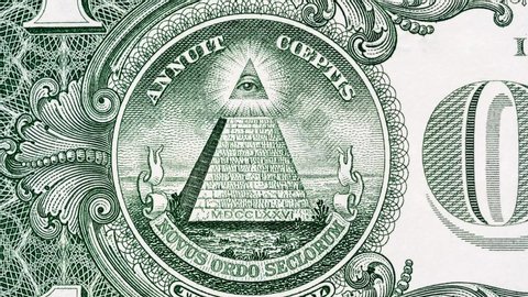 Creative 4k video of details of a 1 american dollar banknote macro closeup with a pyramid and the effect of a glowing mason eye on top. Pyramid close-up on a banknote of 1 US dollars. 