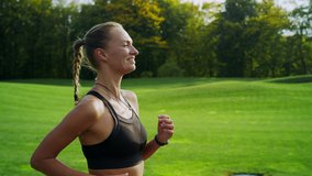 Portrait of smiling handicapped athlete jogging on road. Fitness girl running on in park. Close up runner woman legs training outdoors in slow motion. Disabled woman running outside. - Powered by Shutterstock - Get 15% off with code: PIKWIZARD15