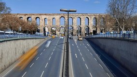 Time lapse clip near Valens Aqueduct (Bozdogan Su Kemeri) on sunny winter day with traffic of cars, Istanbul, Turkey. It was a water-providing system of the Eastern Roman capital Constantinpole