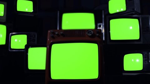 Ten Old TVs turning on Green Screens. Dark Blue Tone. You can Replace Green Screen with the Footage or Picture you Want with “Keying” effect in After Effects (check out tutorials on YouTube). 