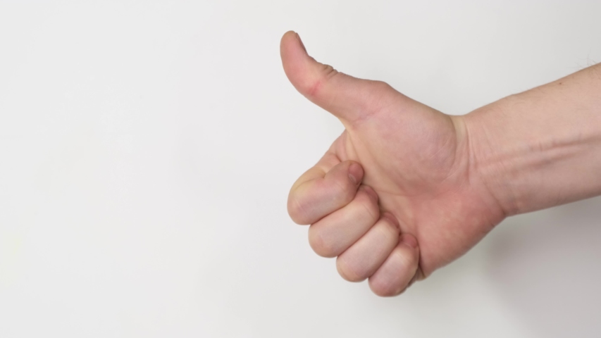 Thumbs up sign hand gesture on white background. Simbol of approval like positive emotion. Close up.