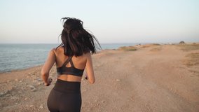 Young adult athlete woman training outdoors and enjoy running near sea
