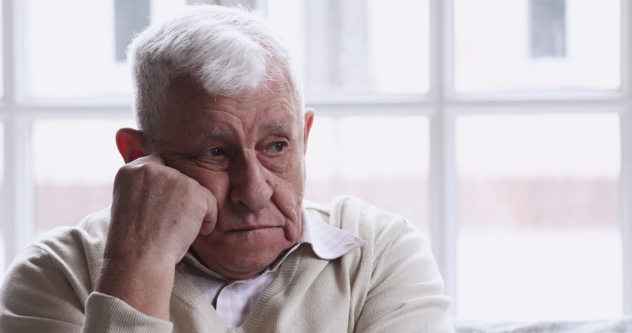 Sad thoughtful lonely senior 70s man sit alone at home look away think of solitude grief. upset depressed retired old adult grandfather feel pain anxiety suffer from loneliness concept, close up view. Royalty-Free Stock Footage #1047422581
