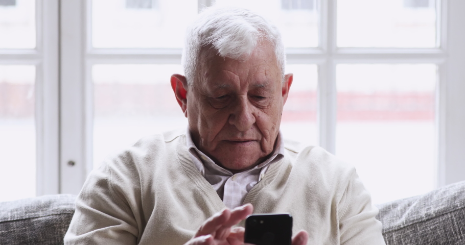 Overjoyed senior old 80s man hold phone look at screen excited about mobile app sport bet bid win concept. happy elder grandfather winner celebrate victory success read good news in cell text message. | Shutterstock HD Video #1047422584