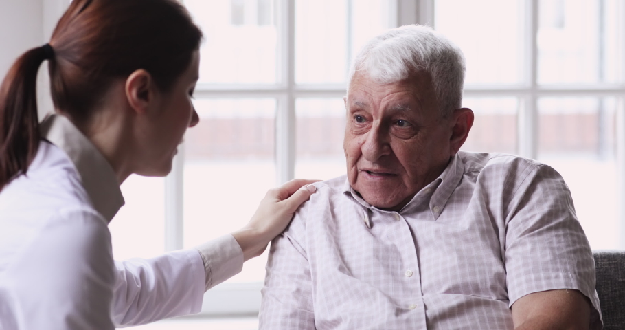 Female doctor caregiver supporting senior grandpa male patient giving advice talking helping aged man during medical visit, elder care treatment, medicare responsibility older people healthcare | Shutterstock HD Video #1047425101