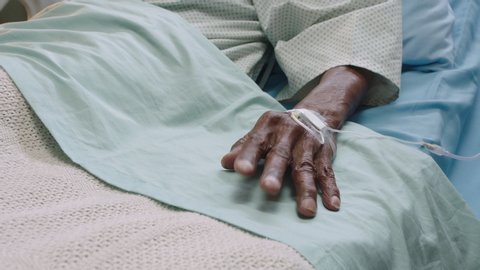 old man in hospital bed moving finger waking up from coma elderly patient with intravenous drip in hand receiving medical treatment modern healthcare