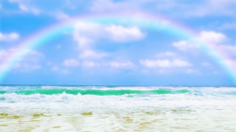 Rainbow over the sea. Waves of turquoise color wash the sandy beach. Beautiful weather after rain. Static long shot.