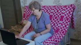 Grandmother talks to family via video calling using laptop and internet