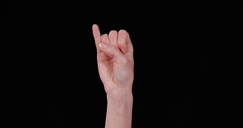 Woman showing J letter on black background, closeup. Sign language