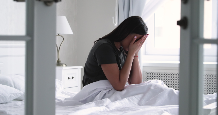 Depressed young african american woman sit in bed wake up feel stress anxiety after bad sleep nightmare dream concept sit alone in bedroom, worried mixed-race lady suffer from insomnia in the morning Royalty-Free Stock Footage #1047458662