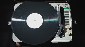 Video of woman with red nails turning on old gramophone