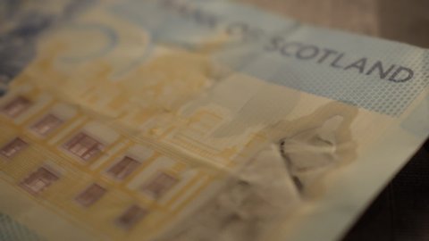 Scottish pound with one euro coin