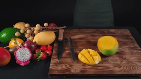 Video of woman cuts vietnamese mango on wooden board