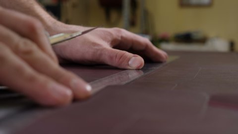 Leather master cutting material. Small private business concept. Process of manufacturing handmade leather wallet, bag. Leatherwork and Workshop concept. 4k video