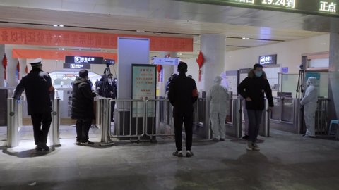 On Feb. 5, 2020 in Jinan, Shandong, China: After the outbreak of new coronavirus in Wuhan, China, staff in protective suit at Jinan Railway Station is taking temperatures of incoming passengers