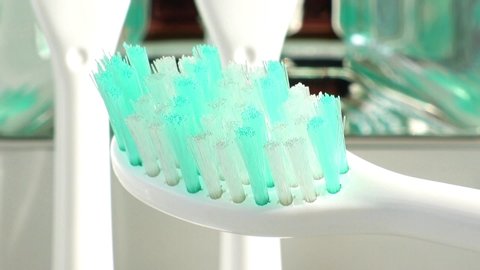 The bristles on the head of the sonic toothbrush vibrate quickly. A electric toothbrush oscillates, macro view.