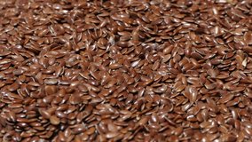 Heap Of Linseed Or Flaxseed Grain Rotating . macro shot of natural organic Linseed. Linseed Overhead View Rotating. healthy food video. beauty ingredients. drink and food background
