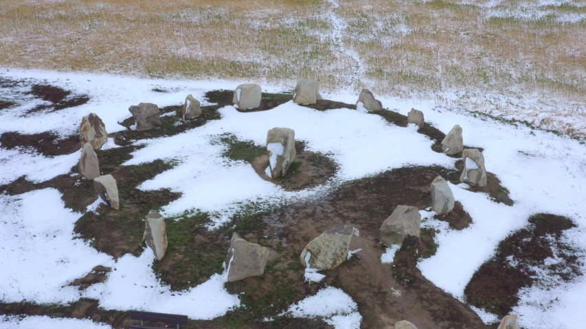 Ancient stone circle from above. Snowy megalith monument in field near Pilsen. Discovery landmark from bronze age in Czech Republic.