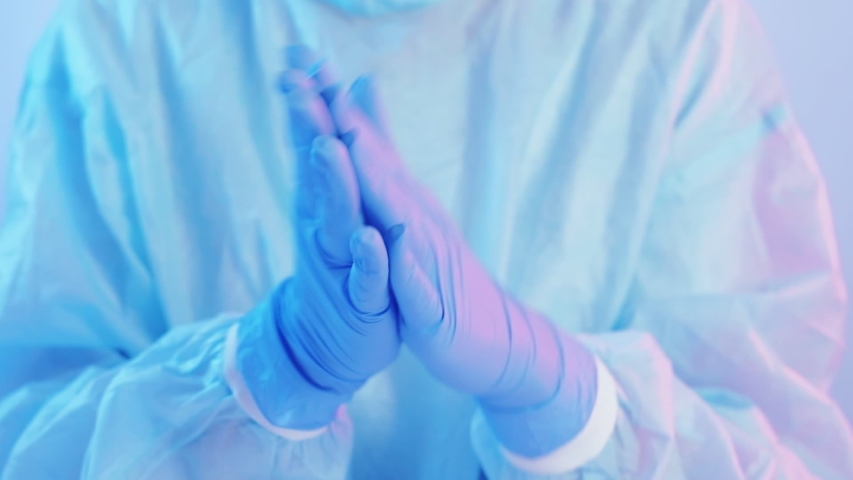 Covid pandemia breakout. Medical staff protection. Female physician wearing blue latex gloves on hands. Royalty-Free Stock Footage #1047512359
