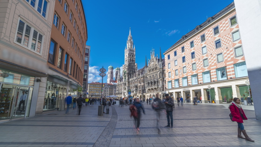 Tourists at the Marienplatz street in Munich Germany view in front of Town Hall catedral. The Marienplatz is central square in the city centre of Munich, Germany. Hyperlapse footage Skyline Munich.   Royalty-Free Stock Footage #1047512437