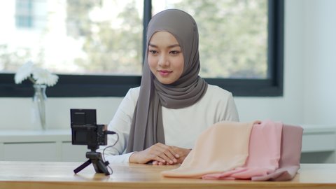 Muslim woman influencer talking and reviewing product hijab for sale marketing online at home. Content for online vlog, modern occupation profession job Online influcencer on social media concept.