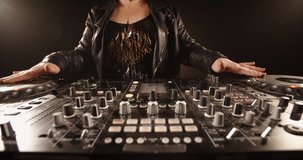 Cool grandma dj rocking the party. Authentic mature woman is composing a dance music list at mixer controller, or working in a nightclub 4k footage