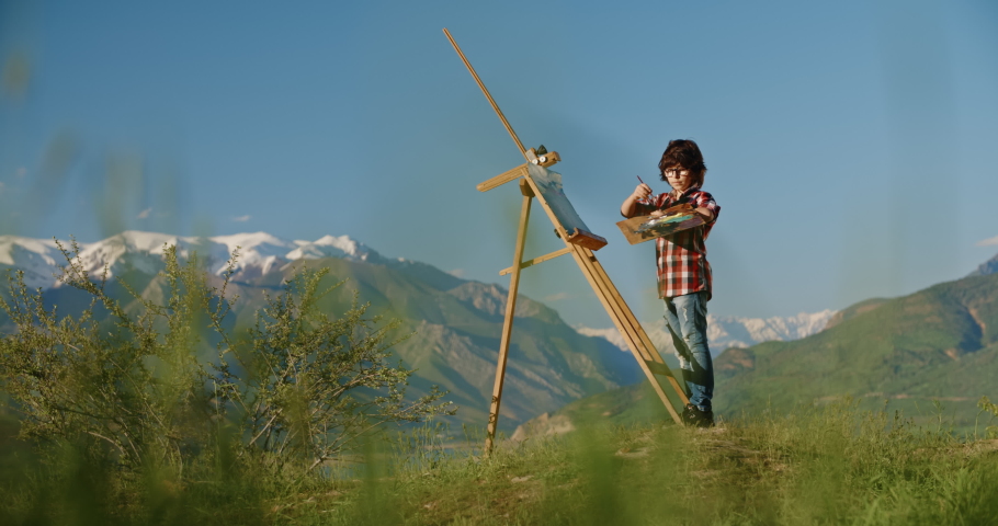 Young boy creating an artpiece, inspired by beauty of lake in mountains, making his dream of becoming artist come true - childhood memories, inspiration 4k