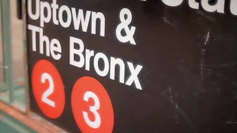 NEW YORK - FEB 9, 2010: 125 Street Station sign for Uptown and The Bronx 2 and 3 subway train line in Harlem NY. Harlem is a famous neighborhood in Manhattan, NYC, USA.