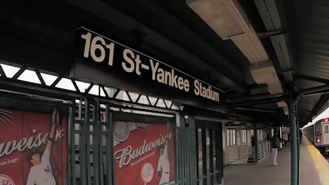 NEW YORK - FEB 9, 2010: Yankee Stadium sign, subway platform at 161 street in the bronx, 4 train entering station, NY. Yankee Stadium is home of the New York Yankees baseball franchise in NYC, USA.