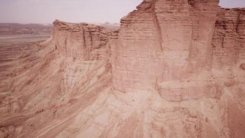 Ascending drone shot of Edge of the World, beautiful mountainous desert landscape near Riyadh in Saudi Arabia
