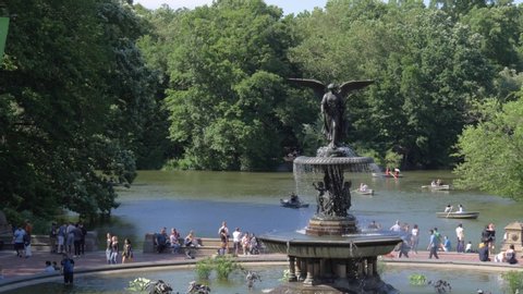 New York City , New York / United States - 06 12 2019: Slow motion establishing shot of Bethesda Fountain and The Lake in Central Park, New York City - June 2019