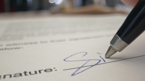 Signature by Pen in Male Hand. Sign Document on Deal at Office Work Indoors. Write Business Agreement or Underwrite Information in Contract. Initials of Partner on Registration Certificate or License