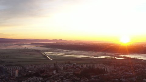 Sunrise over some fields foggy mystical aerial shot Arles France 
