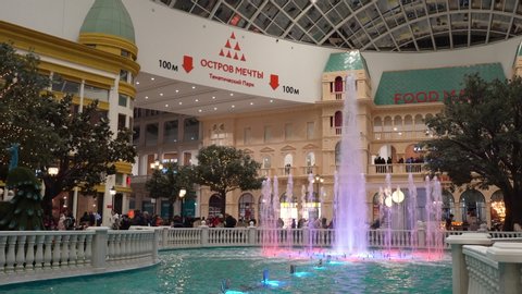 Moscow, Russia - February 29 2020: "Dream island" indoor amusement park central hall fountain. Modern shopping mall interior