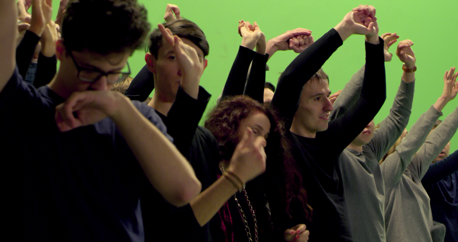 GREEN SCREEN CHROMA KEY Model released, Side view of huge crowd jumping and cheering at a concert or a show. Shot on RED Helium 8K in RAW