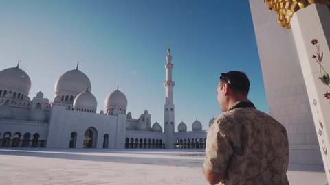 Young Caucasian Man Taking Picture of Sheikh Zayed Grand Mosque as He Visits Abu Dhabi in UAE. Foreign Tourist with Professional Photo Camera Exploring Arab Countries in Middle East
