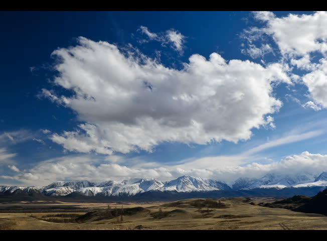 Clouds flying over mountain foothill