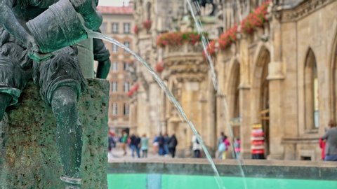 Locked down real time medium shot of the Figure of a boy on the famous fish fountain on the Marienplatz in Munich, November 27, 2019 in Munich, Germany.