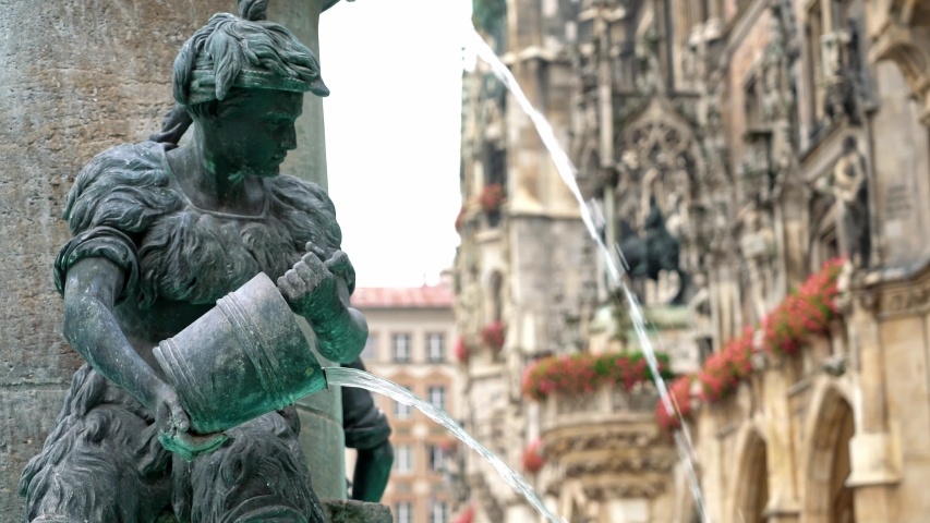 Locked down real time medium shot of the Figure of a boy on the famous fish fountain on the Marienplatz in Munich, November 27, 2019 in Munich, Germany.