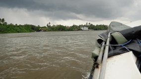 4k video of motorboat sailing on river at rainforest at cloudy day before tropical rain storm