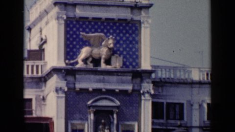 VENICE ITALY-1960: A Gryphon Stands Watch Out Side A Building While Birds Circle