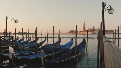 Video of an empty Venice in Italy; a swinging boat on the shore; no people; coronavirus in Italy
