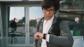 Young Successful Businessman Standing in the City. Looking at his Stylish Watch.
